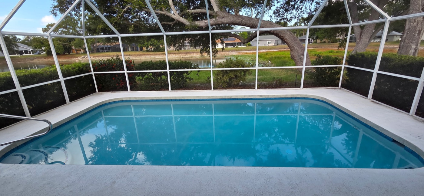 The same pool after renovation, resurfaced and filled with clear blue water